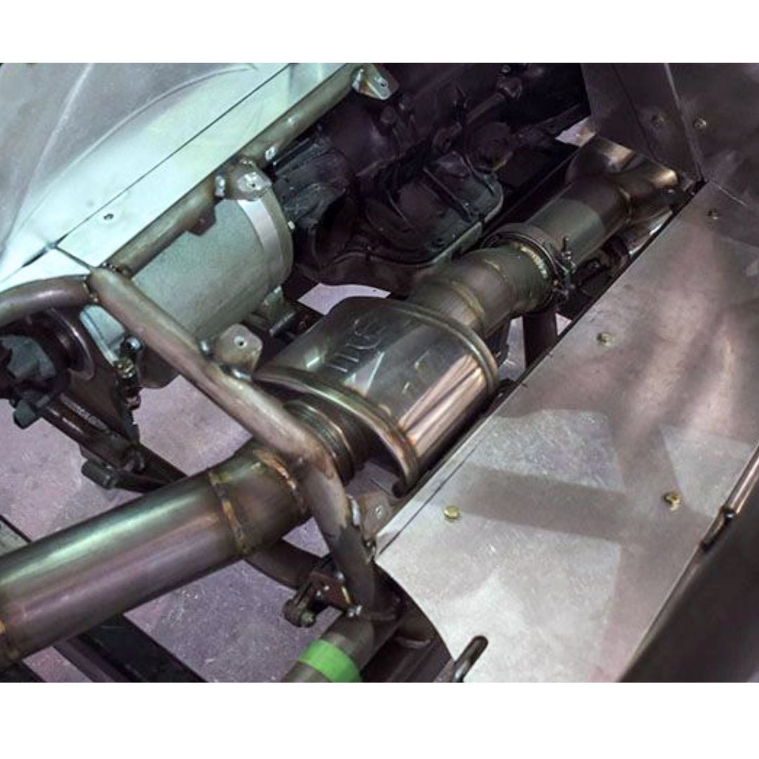 Close-up of a high flow muffler for custom exhaust fabrication with metal pipes and components.