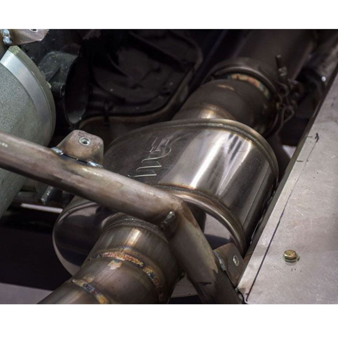Close-up of a stainless steel muffler for rock crawler exhaust with visible Magnaflow branding.