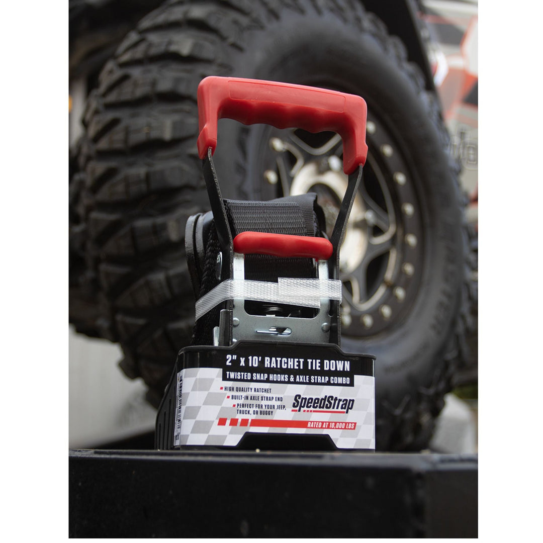 SpeedStrap 2 tow strap with red handles in front of a vehicle tire.
