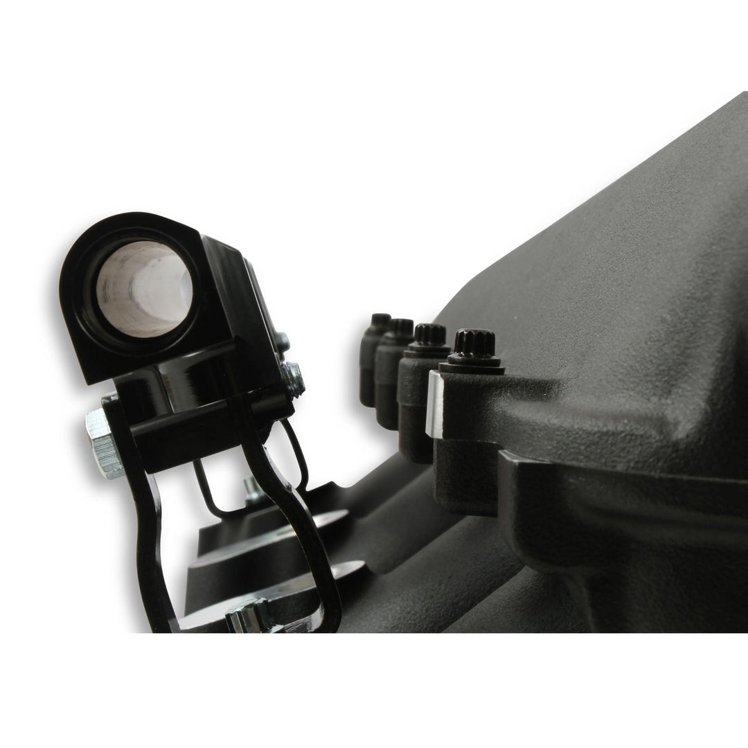 Close-up of a black Lo-Ram intake manifold kit attached to a dark engine component, with visible bolts and nuts on a white background.