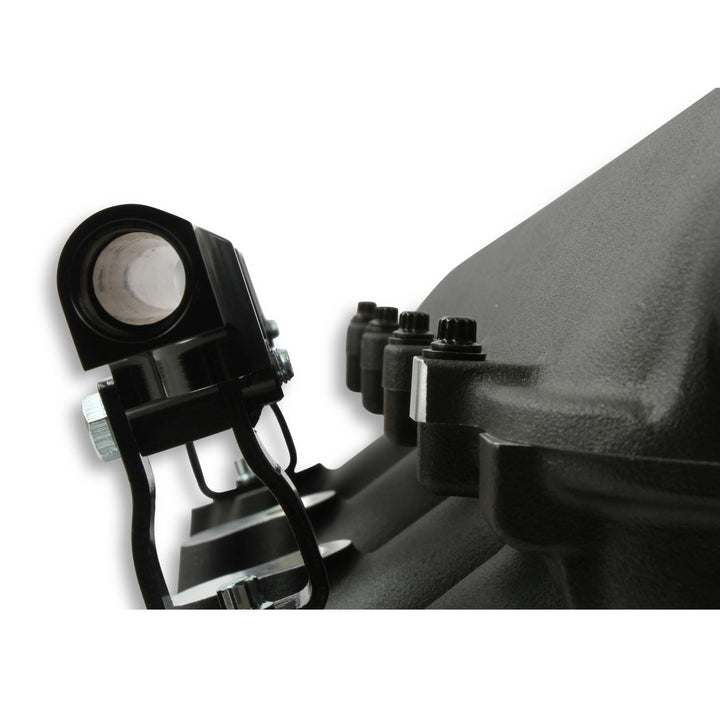 Close-up of a black Lo-Ram intake manifold kit attached to a dark engine component, with visible bolts and nuts on a white background.
