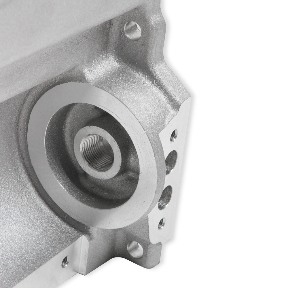 Close-up of a LS swap oil pan for Fox Body Mustang with a threaded hole and mounting holes, shown on a plain white background.