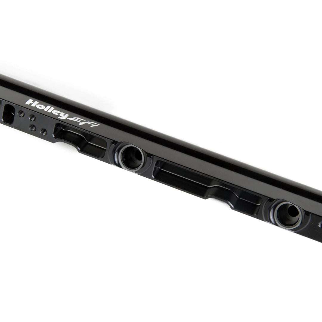 Close-up of a LS3 high flow fuel rails
with visible mounting holes and the white Holley EFI brand name printed on the side, set against a plain white background.