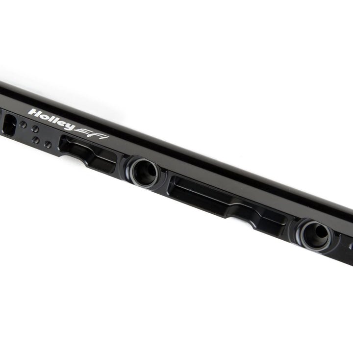 Close-up of a LS3 high flow fuel rails
with visible mounting holes and the white Holley EFI brand name printed on the side, set against a plain white background.