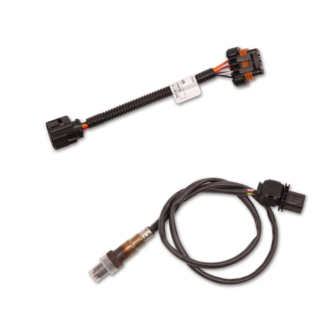 A pair of Terminator X Max 58x 4x EV6 harness electrical sensor connectors with attached black cables, shown on a plain white background. One connector has a clear plastic cap, and both have black multi-pin plugs with orange accent rings.