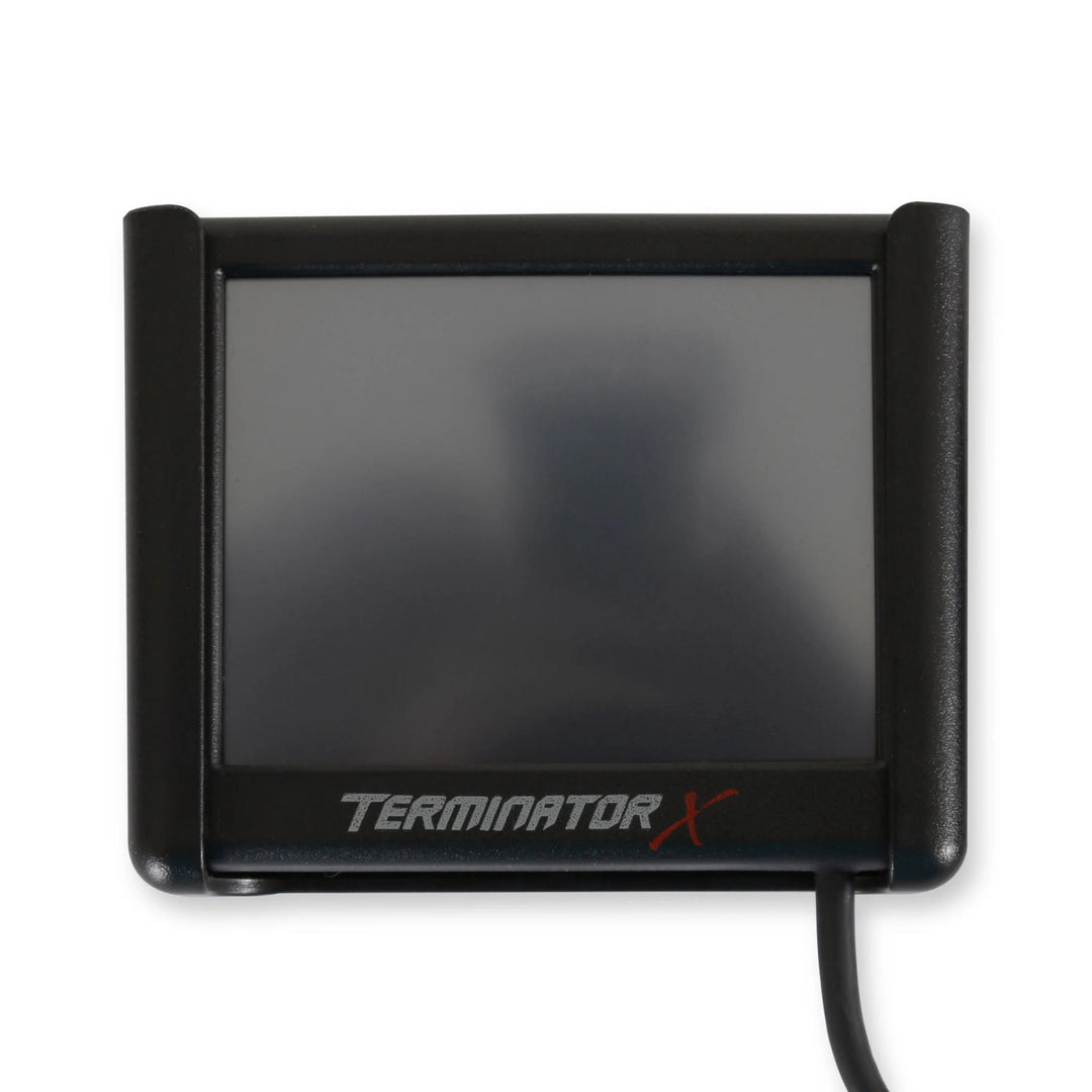 A black Terminator X LCD tuning display with a dark screen and a visible cable, shown on a plain white background.