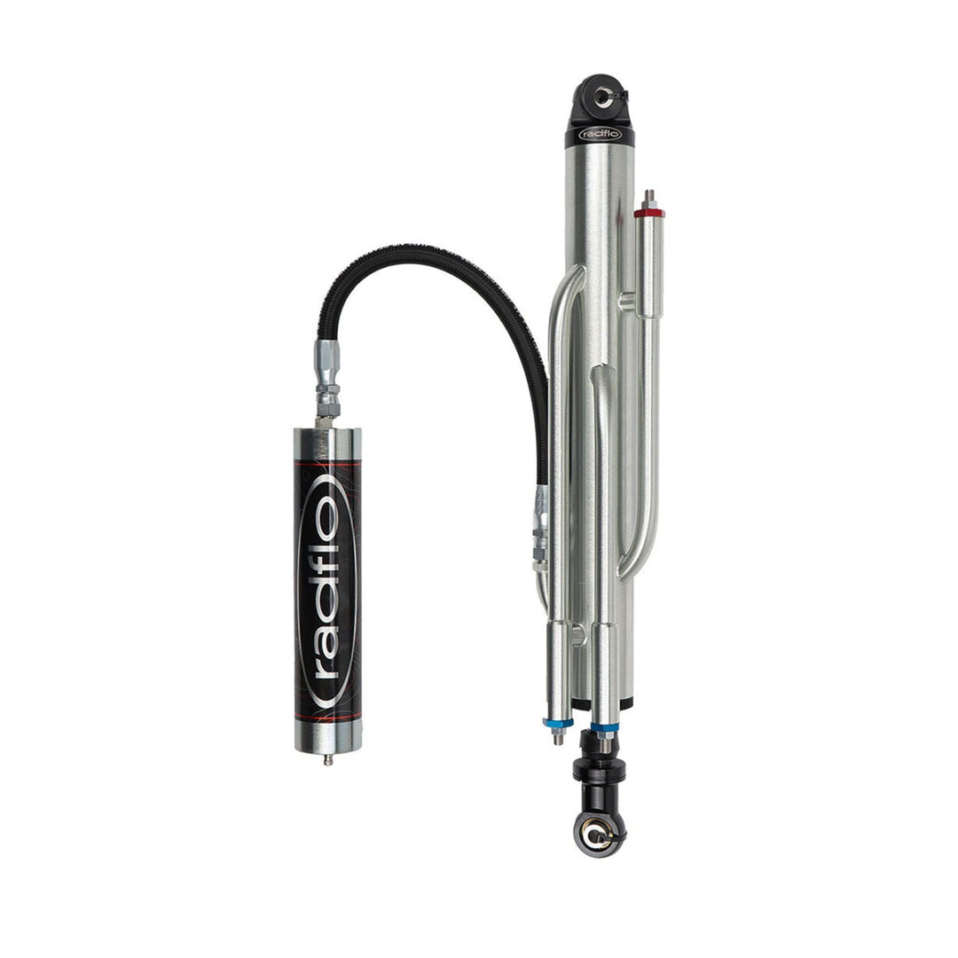 A Radflo 3.0 external bypass shock and remote reservoir, featuring a silver metal cylinder, black hose, and a separate black and silver reservoir canister with the &