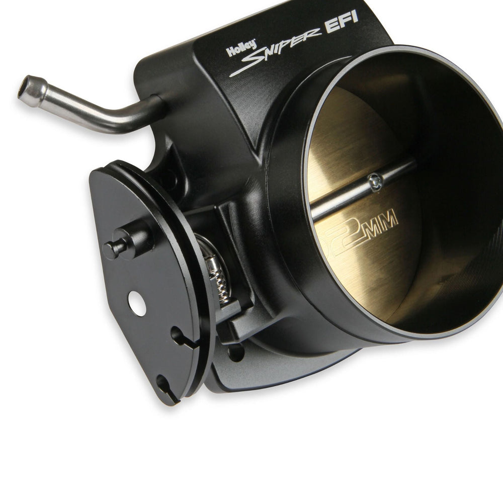 Holley Sniper EFI 102mm throttle body for LS engine with a black anodized finish and a brass butterfly valve, shown on a white background.