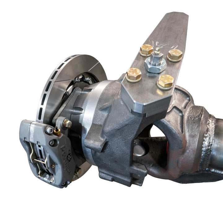 Close-up of a 8620 chromoly off-road steering knuckle adapter with bolts on a white background