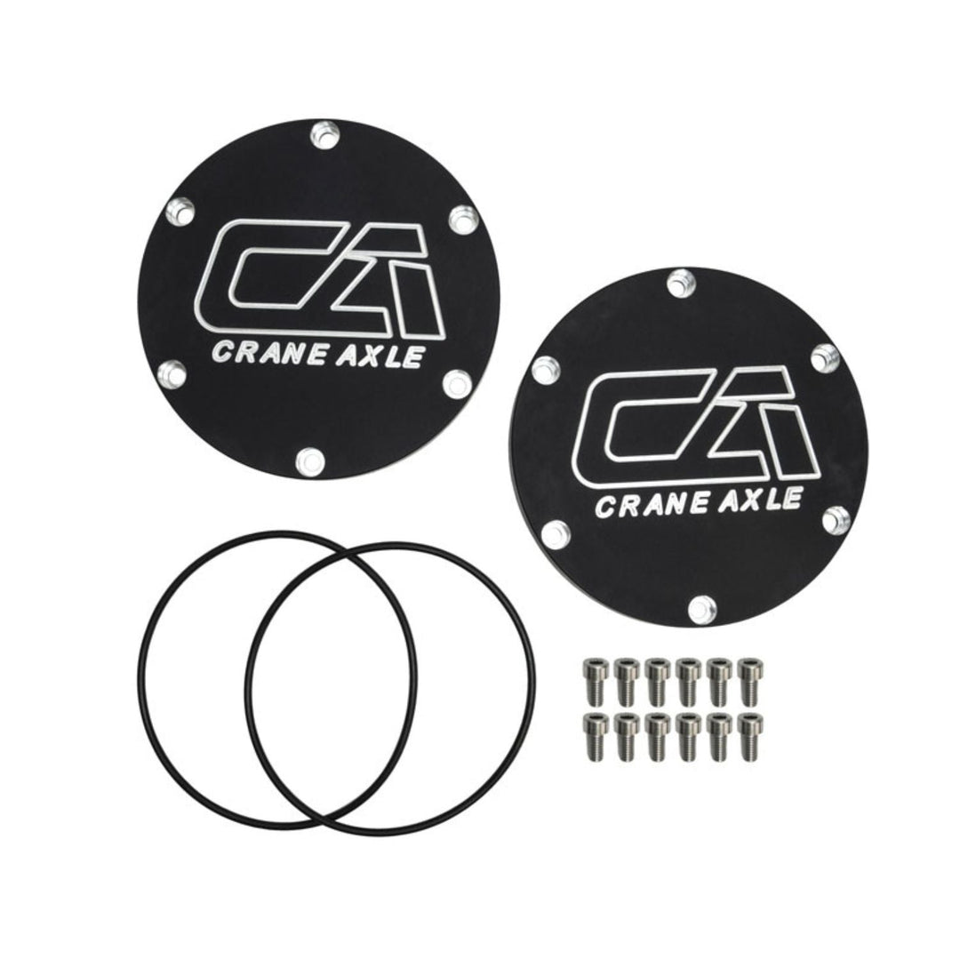 Two black 2005+ Super Duty unit bearing covers with Crane Axle logo and additional components on a white background