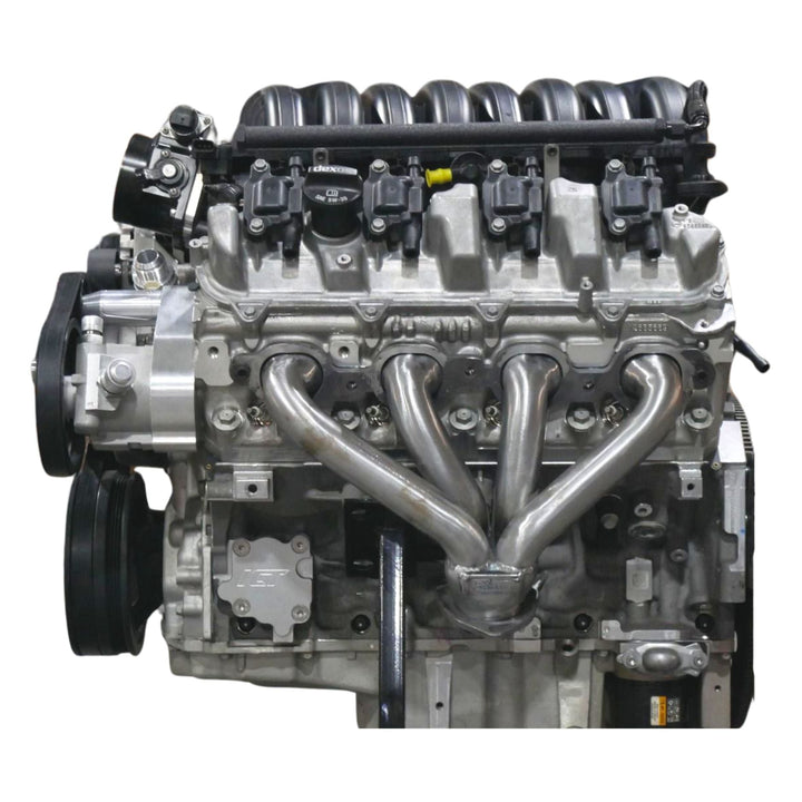 LT engine Jeep swap headers installed on a white background