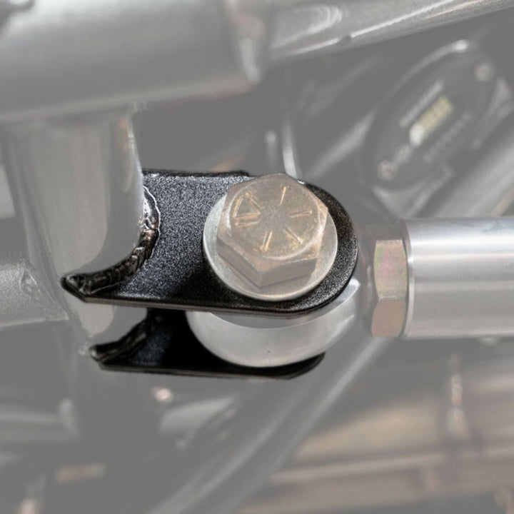 Close-up of off road suspension link mounting kit with a bolt welded on a chassis 
