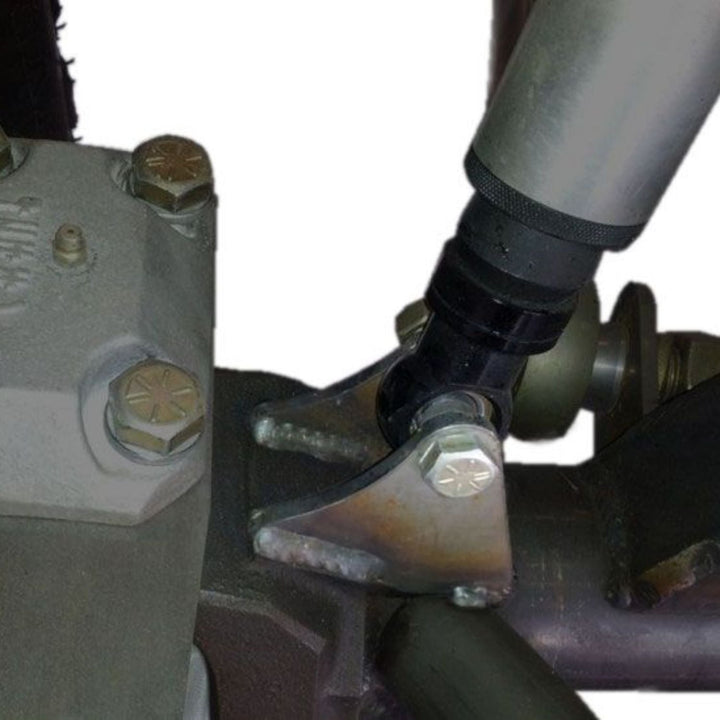 Close-up of Dana 60 Shock Mounts installed on a chassis on a white background