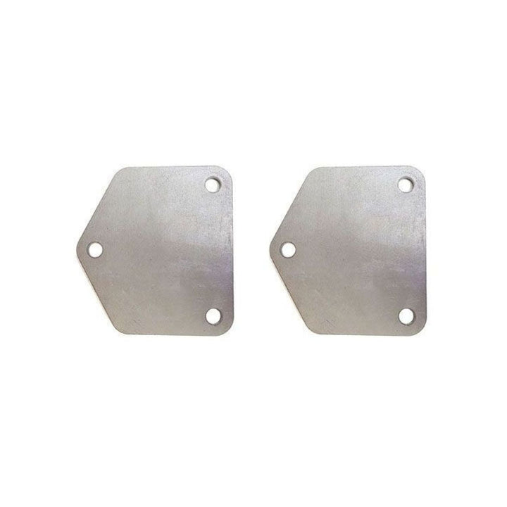 Two old style chevy motor mounts on a white background