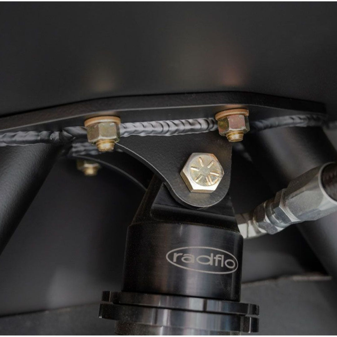 Close-up of a Radflo product with suspension mounting bracket on a dark background