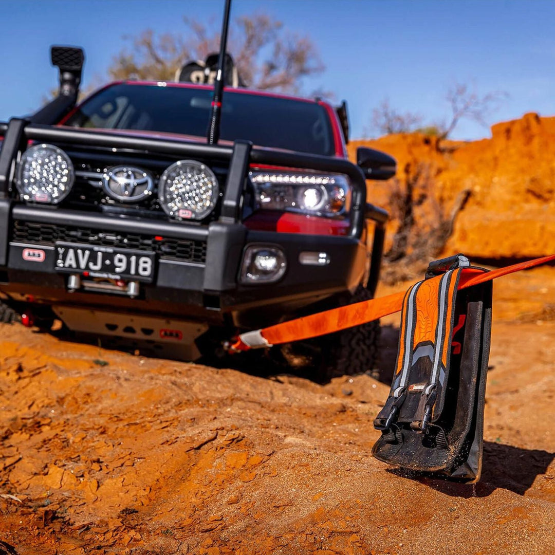 ARB recovery bag and shackles in use on an Off-road vehicle with a winch on a rocky terrain