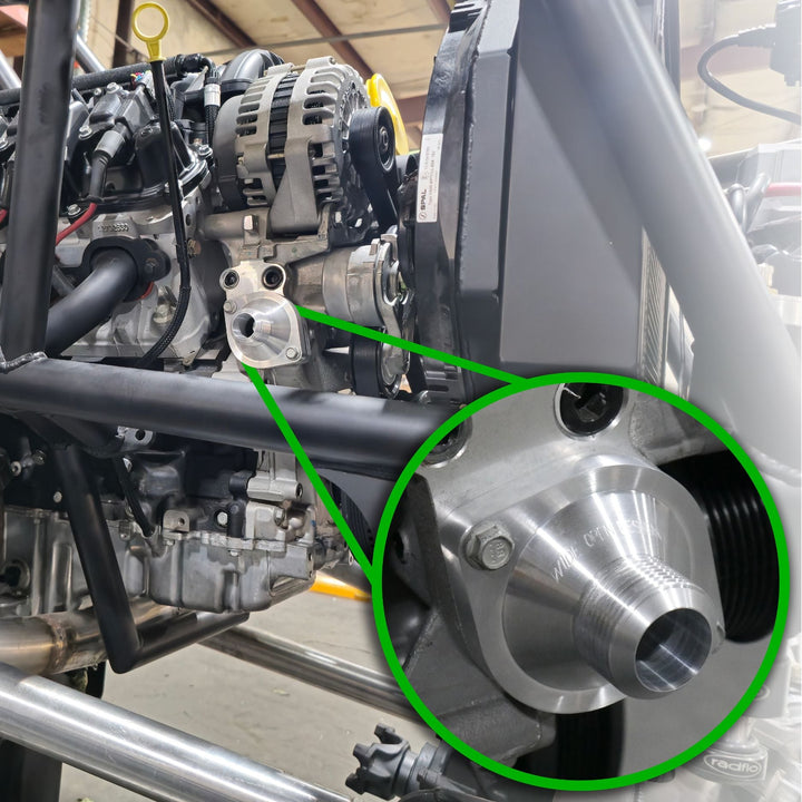 Close-up of a GM LT engine with a green circle highlighting a LT swap coolant plumbing -16 AN.