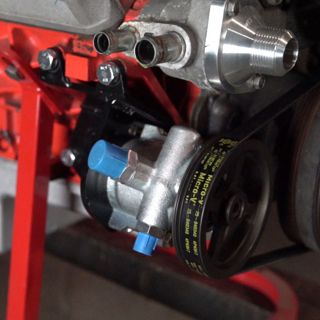 Close-up of off road LS power steering pump bracket kit mounted on an engine with pulley