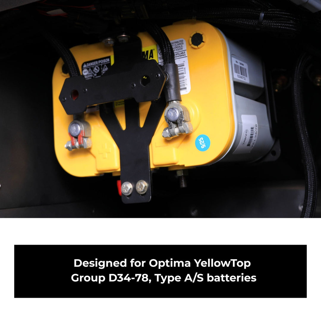 Yellow car battery mounting tray with black bracket inside a vehicle, labeled for Optima YellowTop batteries.