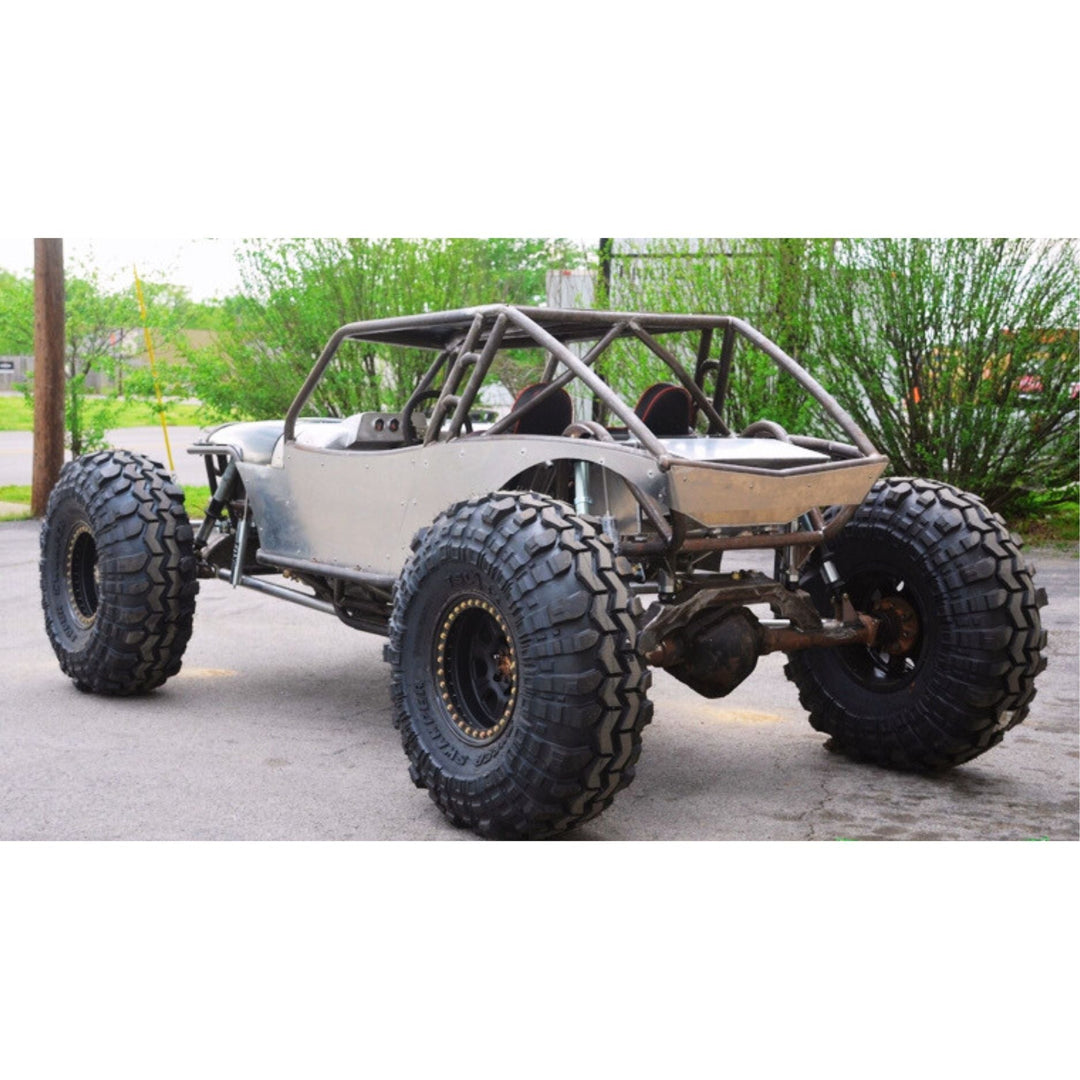 Off-road custom rock crawler chassis with large tires on a paved surface