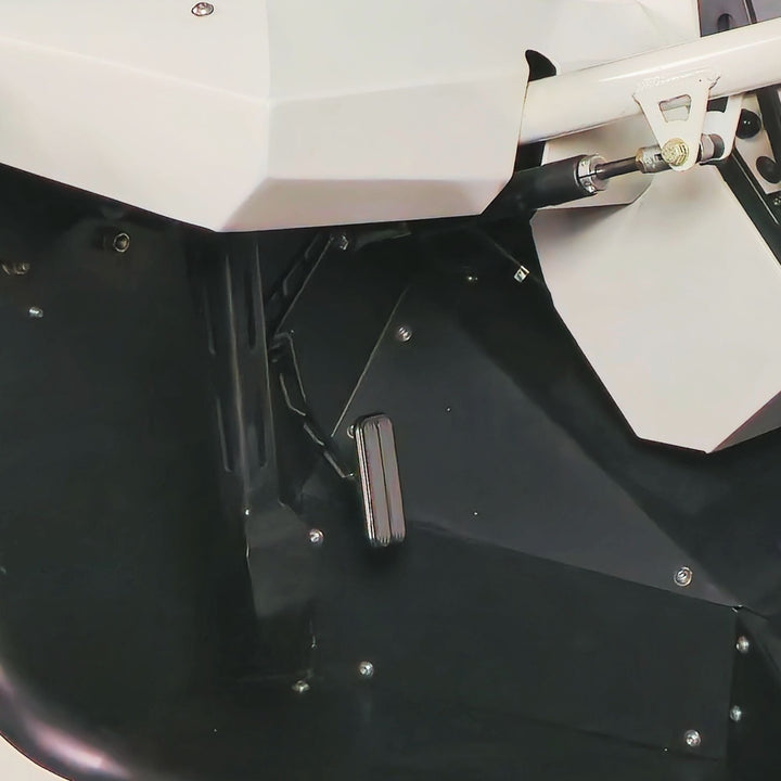 Close-up of a lokar throttle pedal and part of the seat on a black background